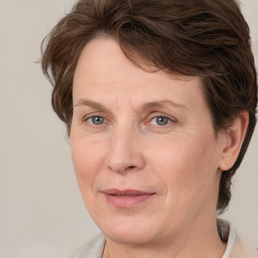 Joyful white adult female with short  brown hair and grey eyes