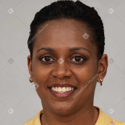 Joyful black young-adult female with short  brown hair and brown eyes