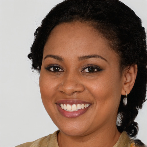 Joyful black young-adult female with medium  brown hair and brown eyes