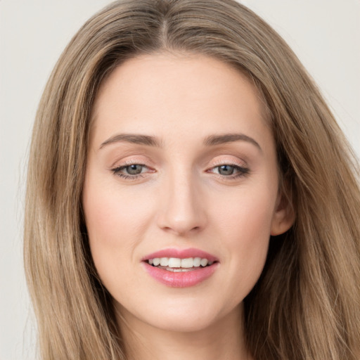 Joyful white young-adult female with long  brown hair and grey eyes