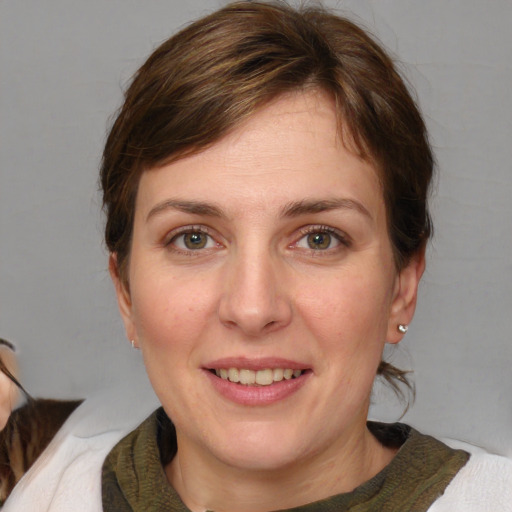 Joyful white adult female with medium  brown hair and grey eyes