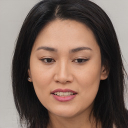 Joyful asian young-adult female with long  brown hair and brown eyes