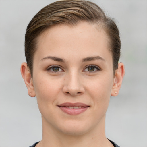 Joyful white young-adult female with short  brown hair and grey eyes