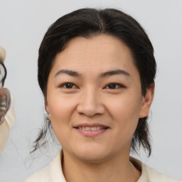 Joyful asian young-adult female with medium  brown hair and brown eyes