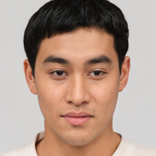 Joyful asian young-adult male with short  black hair and brown eyes