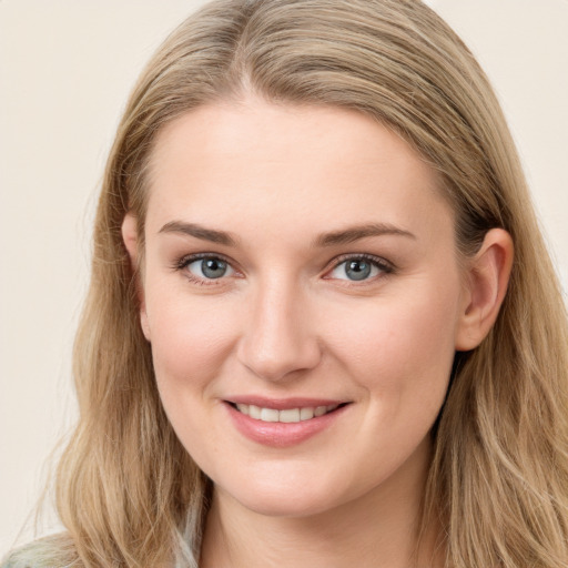 Joyful white young-adult female with long  brown hair and blue eyes