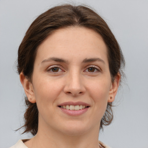 Joyful white young-adult female with medium  brown hair and brown eyes