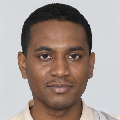 Joyful black young-adult male with short  black hair and brown eyes