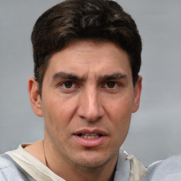 Joyful white adult male with short  brown hair and grey eyes