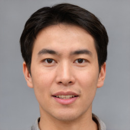 Joyful asian young-adult male with short  brown hair and brown eyes