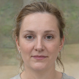 Joyful white adult female with medium  brown hair and grey eyes