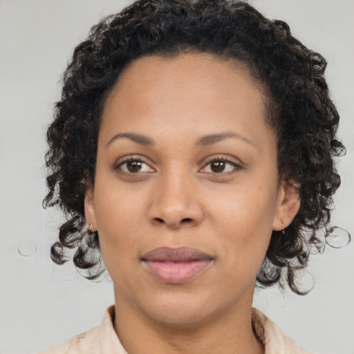 Joyful black young-adult female with medium  brown hair and brown eyes