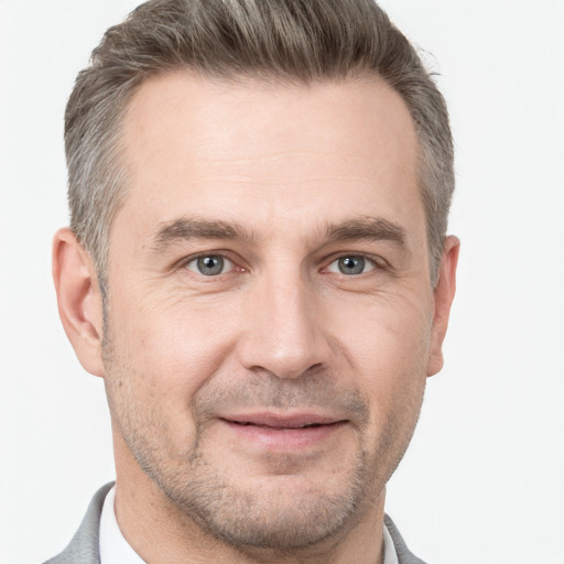 Joyful white adult male with short  brown hair and grey eyes