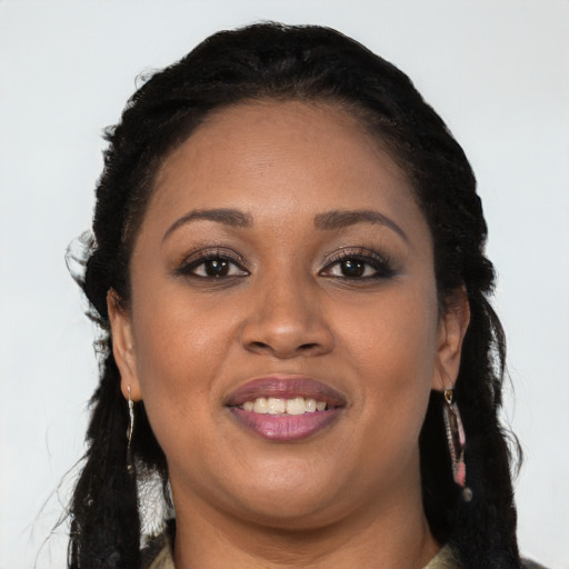 Joyful black young-adult female with long  black hair and brown eyes