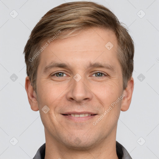 Joyful white adult male with short  brown hair and grey eyes