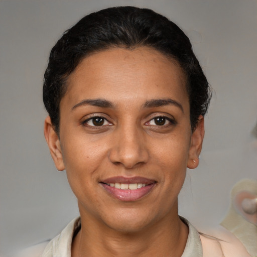 Joyful latino young-adult female with short  black hair and brown eyes