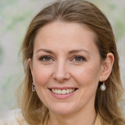 Joyful white adult female with long  brown hair and grey eyes