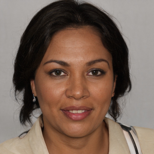 Joyful black young-adult female with medium  brown hair and brown eyes