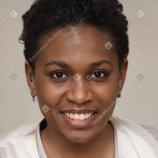 Joyful black young-adult female with short  brown hair and brown eyes