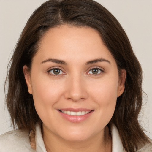 Joyful white young-adult female with medium  brown hair and brown eyes