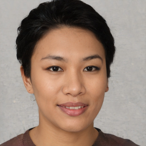 Joyful asian young-adult female with short  black hair and brown eyes