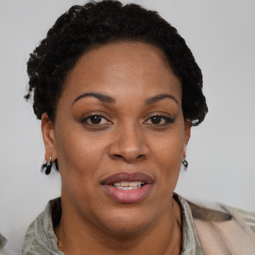 Joyful black adult female with short  brown hair and brown eyes