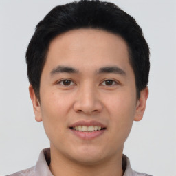 Joyful asian young-adult male with short  black hair and brown eyes