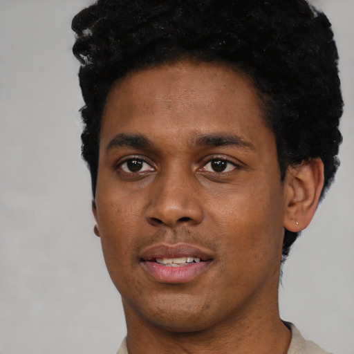 Joyful black young-adult male with short  black hair and brown eyes