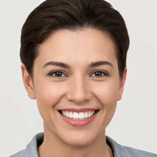 Joyful white young-adult female with short  brown hair and brown eyes