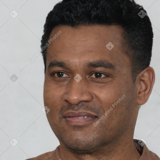 Joyful black young-adult male with short  black hair and brown eyes