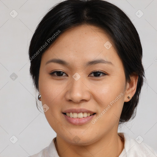 Joyful asian young-adult female with medium  black hair and brown eyes