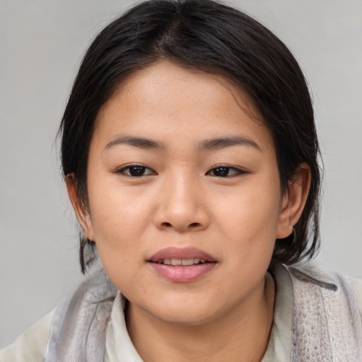 Joyful asian young-adult female with medium  brown hair and brown eyes