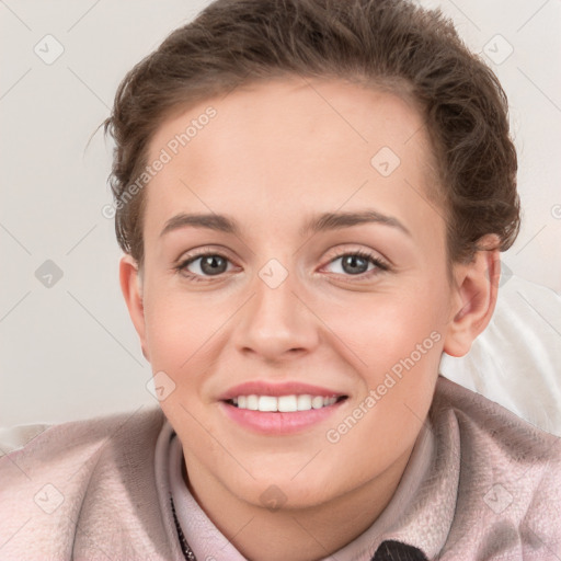 Joyful white young-adult female with short  brown hair and grey eyes