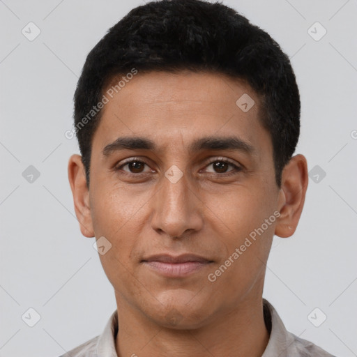 Joyful latino young-adult male with short  black hair and brown eyes