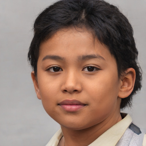 Joyful asian child female with short  brown hair and brown eyes
