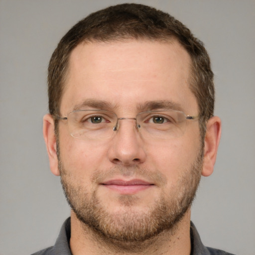 Joyful white adult male with short  brown hair and grey eyes