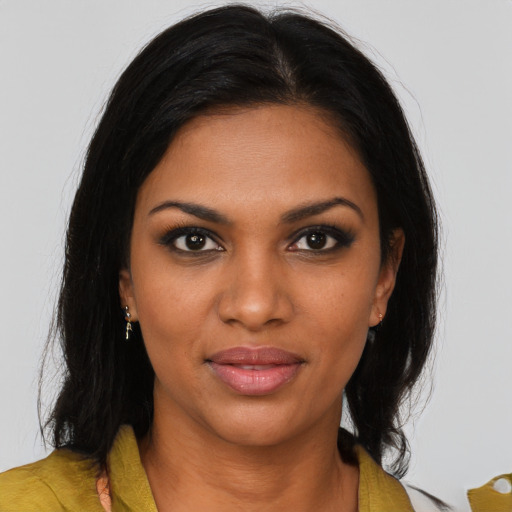 Joyful black young-adult female with medium  brown hair and brown eyes