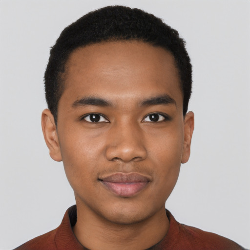 Joyful black young-adult male with short  black hair and brown eyes