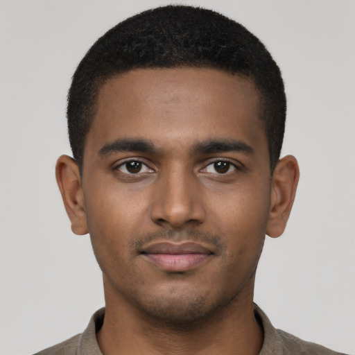 Joyful black young-adult male with short  brown hair and brown eyes