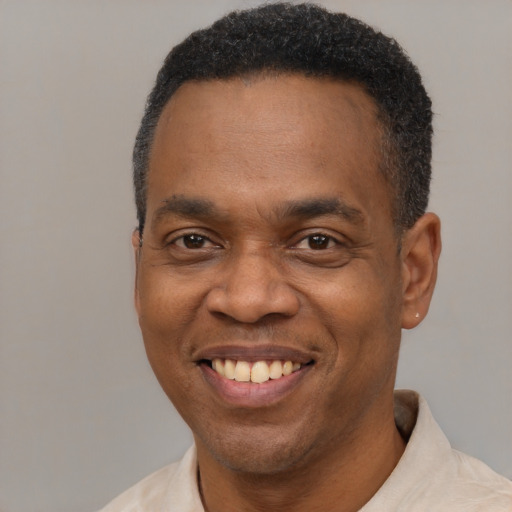 Joyful latino adult male with short  black hair and brown eyes