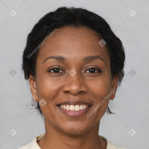 Joyful black adult female with short  brown hair and brown eyes