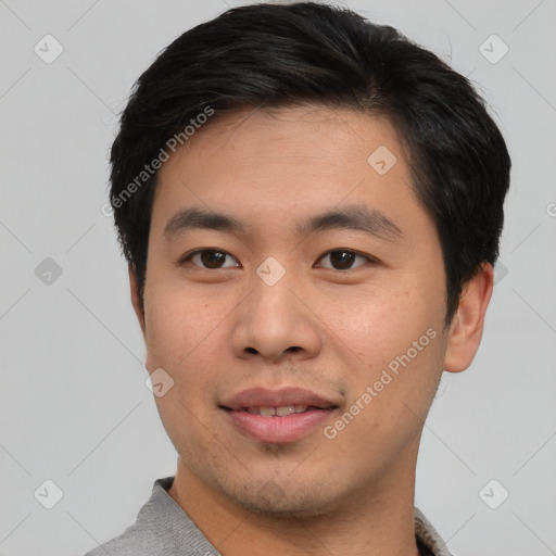 Joyful asian young-adult male with short  black hair and brown eyes