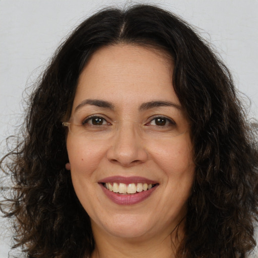 Joyful white adult female with long  brown hair and brown eyes