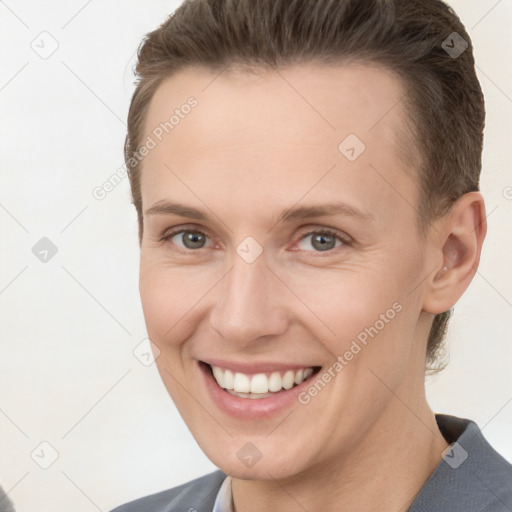 Joyful white young-adult female with short  brown hair and brown eyes