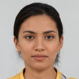 Joyful asian young-adult female with medium  brown hair and brown eyes