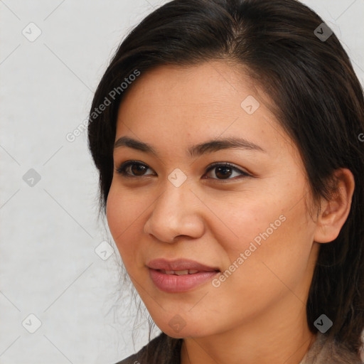 Joyful latino young-adult female with medium  brown hair and brown eyes