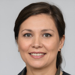 Joyful white adult female with medium  brown hair and brown eyes