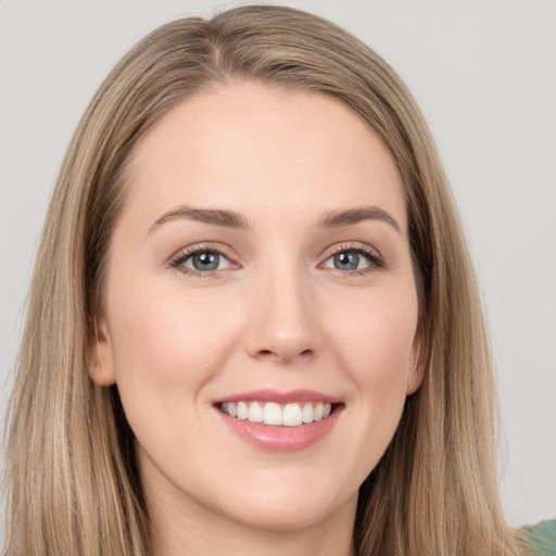 Joyful white young-adult female with long  brown hair and grey eyes