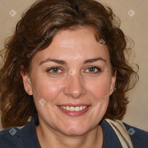 Joyful white adult female with medium  brown hair and blue eyes