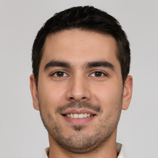 Joyful white young-adult male with short  brown hair and brown eyes